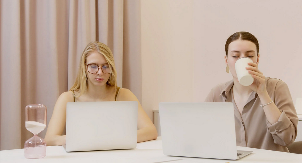 two people working on laptops